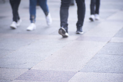 Low section of people walking on footpath