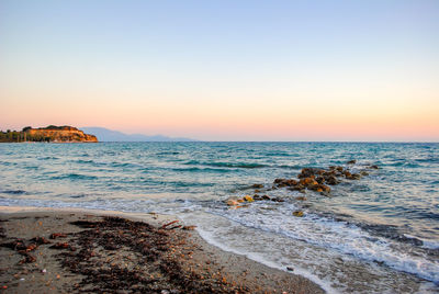 Scenic view of sea against clear sky during sunset