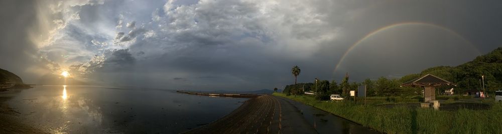 Panoramic view of rainbow over road against sky
