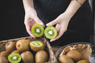 Midsection of woman holding fruits