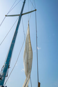 Low angle view of sailboat against clear blue sky