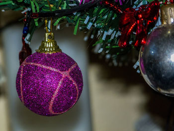 Close-up of christmas decorations hanging on tree