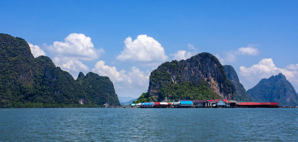 Panoramic view of sea and mountains against sky