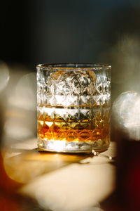Close-up of glass with bourbon whiskey on table