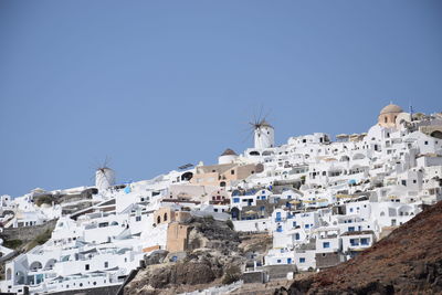 Low angle view of buildings against clear blue sky