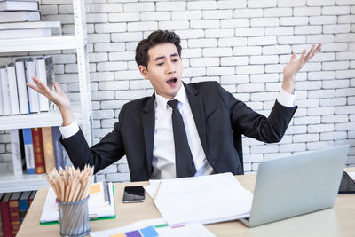 Young man using mobile phone in office