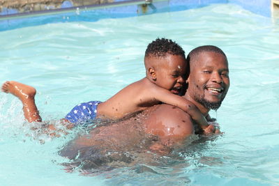 Portrait of shirtless boy in swimming pool