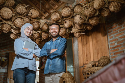 Portrait of smiling couple standing in basket