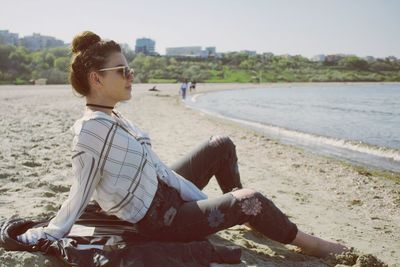 Young woman relaxing on sea shore at beach
