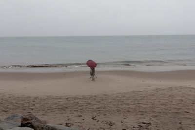 Full length of man on beach against sky