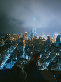 Panoramic view of illuminated city buildings against sky at night