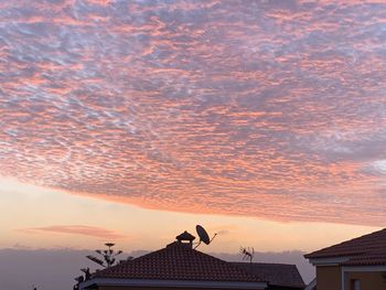 Low angle view of silhouette building against sky during sunset