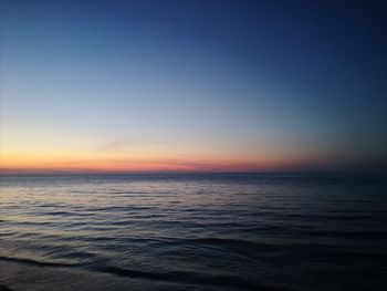 Scenic view of sea against clear sky during sunset