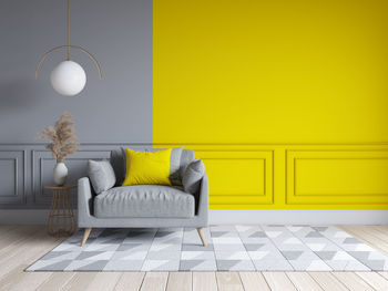 Full frame shot of sofa against yellow wall at home