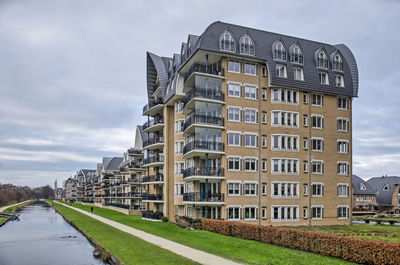 Building by road against sky in city