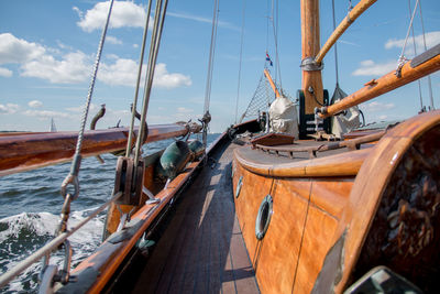 Sailing boat on sea against blue sky