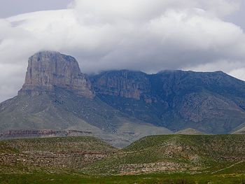 Scenic view of mountains against cloudy sky