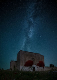 Low angle view of old building against sky at night