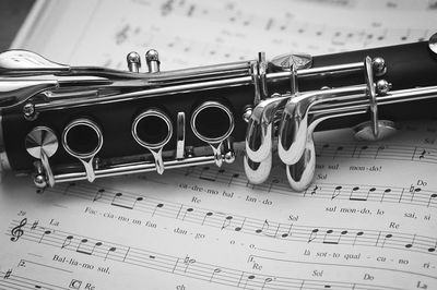 Close-up of flute on musical notes