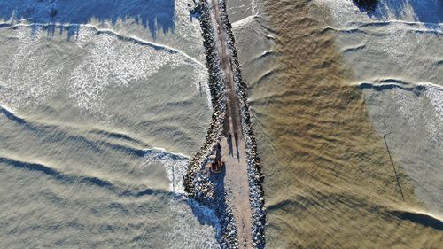 High angle view of surf on sea shore