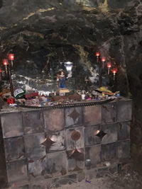 High angle view of illuminated candles in temple