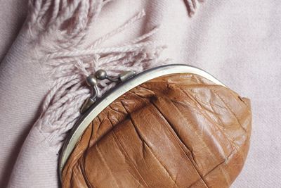 Close-up of brown purse on textile