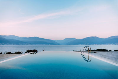 Scenic view of swimming pool by sea against sky