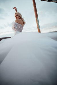 Low angle view of woman against sky