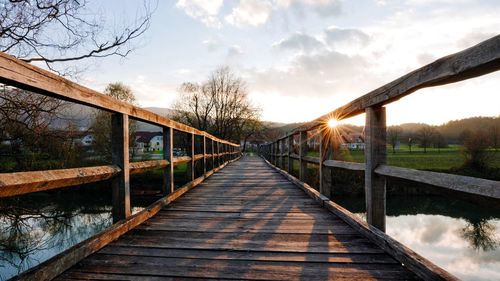 Wooden footbridge. sunset light with sun rays.