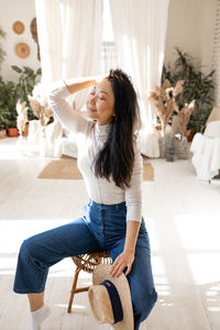 Cozy homely atmosphere. stylish asian woman relaxing at home.