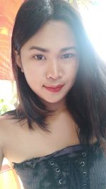 Close-up portrait of a smiling young woman