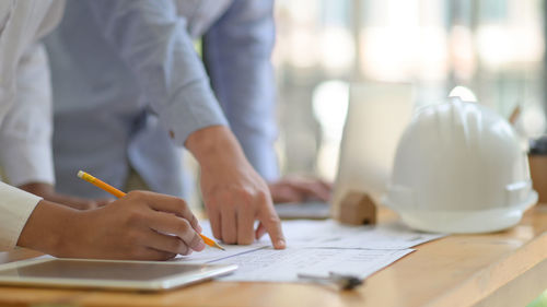 Midsection of woman working on table
