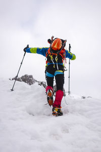 Rear view of person with umbrella on snow