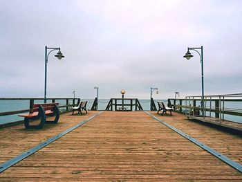 Abandoned seaside telescope . autumn misty morning on wooden pier above sea. dark atmosphere.