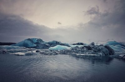 Scenic view of frozen lake against sky