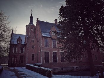 Historic building against sky during winter