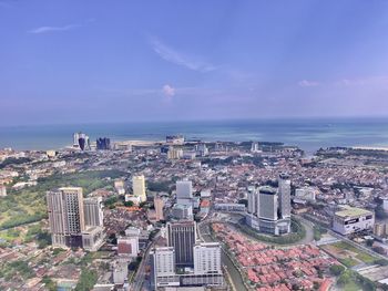 High angle view of buildings and sea against sky