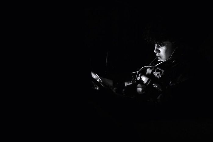 MAN PLAYING WITH BLACK BACKGROUND