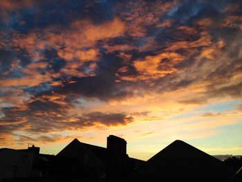 Low angle view of building against sky at sunset