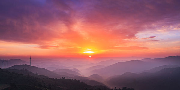 Scenic view of mountains against sky at sunset