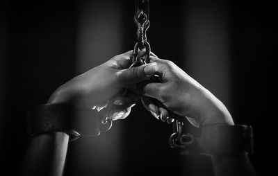 Cropped hands of person with handcuffs