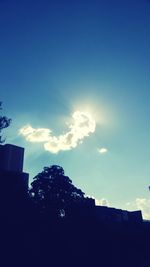 Low angle view of silhouette buildings against sky