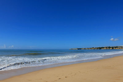 Scenic view of calm sea against clear sky