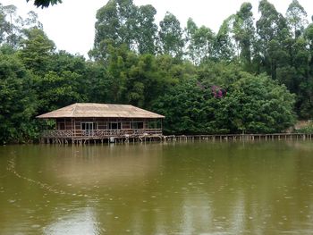 Gazebo by lake against sky