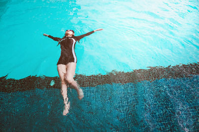 Full length of young man swimming in pool