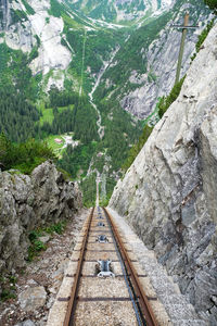 Railroad tracks amidst trees and mountains