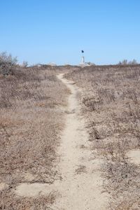 Scenic view of field against clear sky. path leading to nowhere. barren dry landscape. 