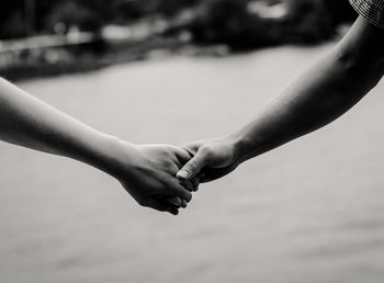 Cropped image of couple holding hands