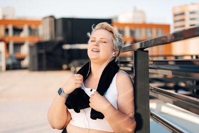 Side view of woman listening music outdoors