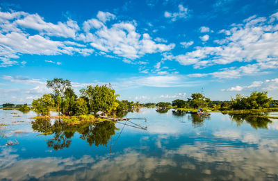 Reflection of trees in lake against sky